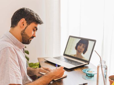 Psychiatrist taking notes while listening to female patient