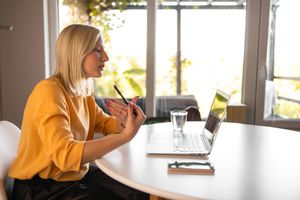 Young woman doing online therapy on her laptop