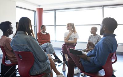 Sad woman sharing with friends and instructor