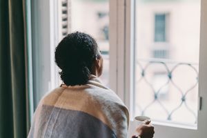 Sad BIPOC woman looking out the window