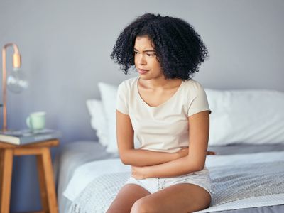 Woman experiencing anxiety-related stomach problems