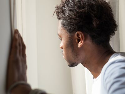 anxious man looking out window