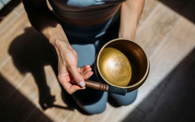 Woman playing singing bowl