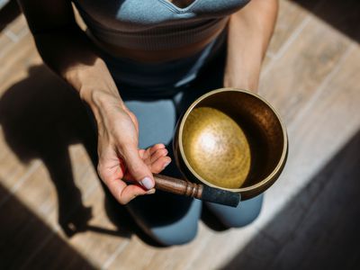 Woman playing singing bowl