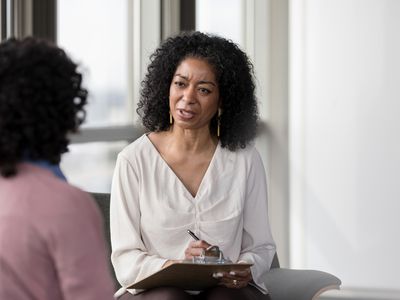 Therapist asks patient questions in session.