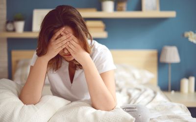 Unhappy girl in a bedroom