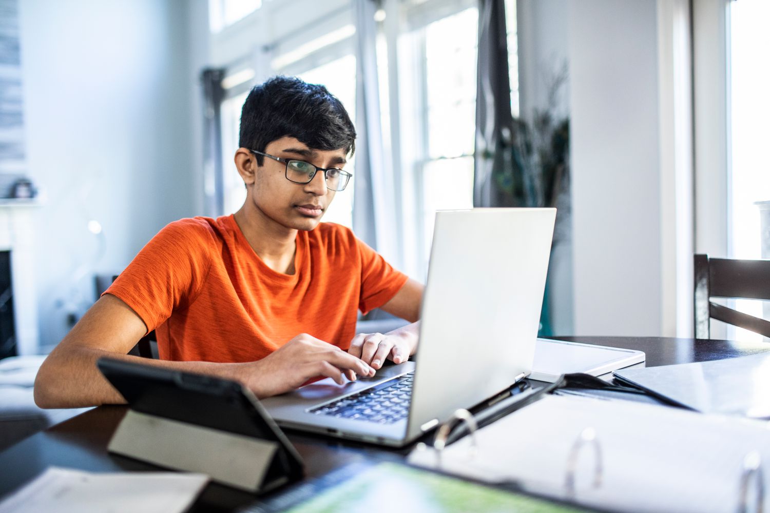 Teen on computer facetiming psychologist 