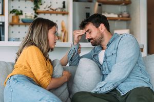 Shot of young wife expressing empathy and compassion to her sad frustrated husband.