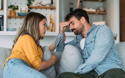 Shot of young wife expressing empathy and compassion to her sad frustrated husband.