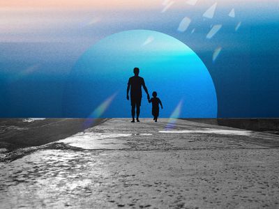 Child walking with father on a paved path with a moon backdrop