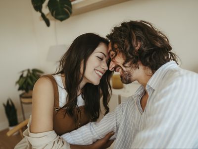 Happy couple touching foreheads at home