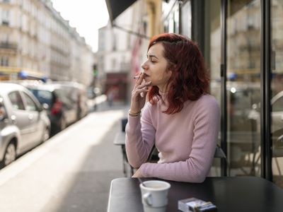 Woman smoking in outdoor cafe