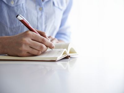 woman writing in notebook