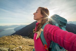 woman feeling free at top of mountain