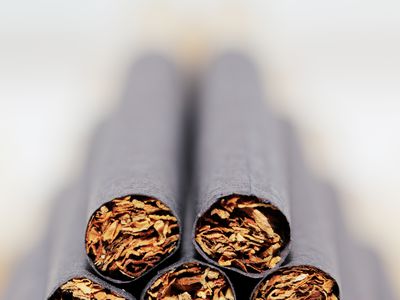 Clove cigarettes on white background