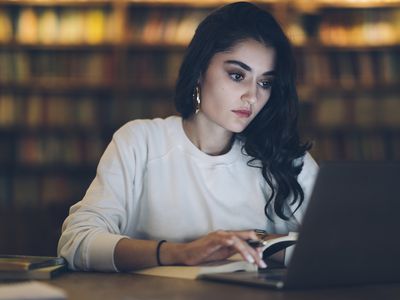 Young college student studying at library