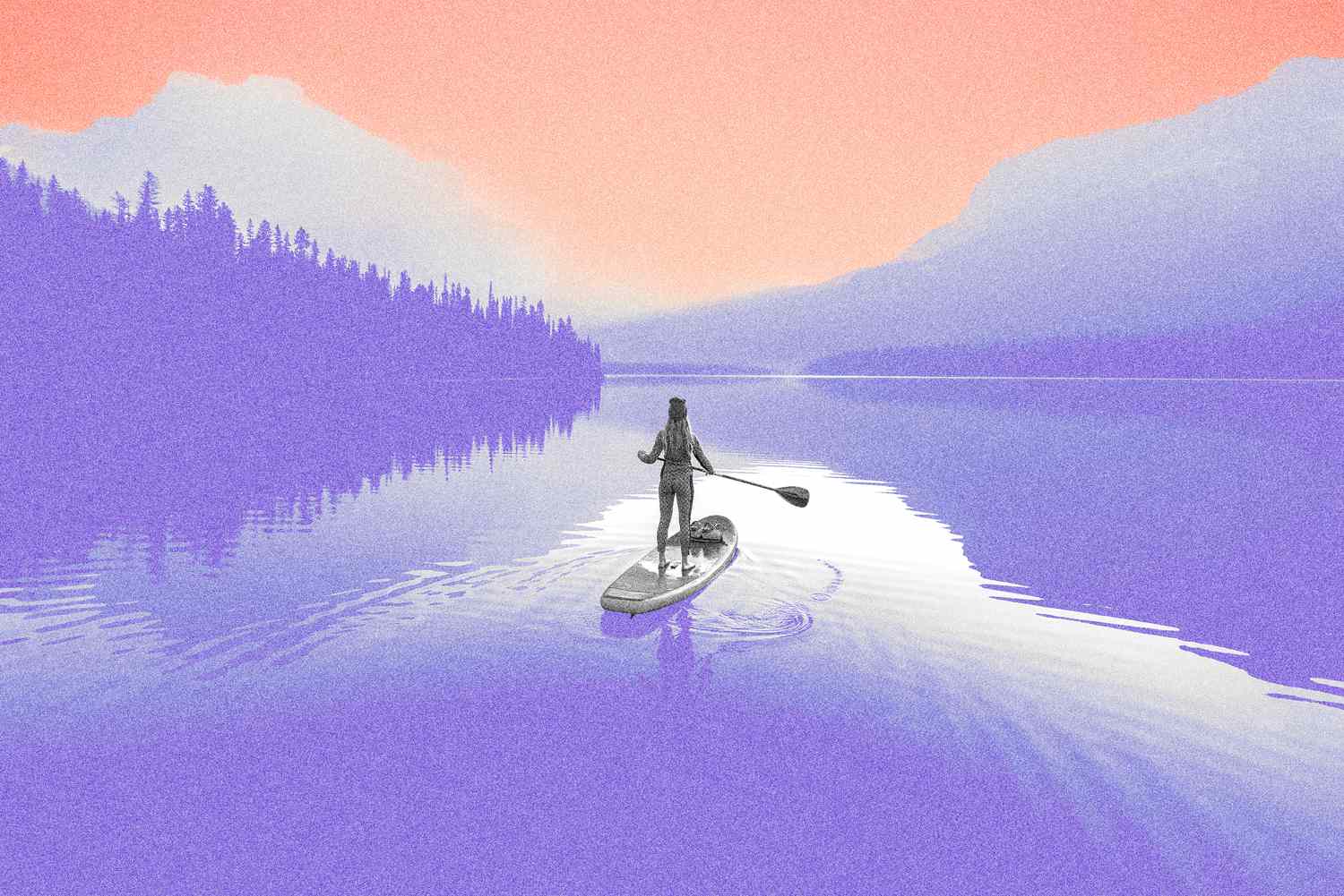 A young woman paddleboarding on Emerald Lake at sunrise in Yoho National Park.